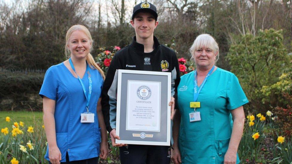 Max Woosey, pictured with Andrea Crisp (left) and Dee Thorne of North Devon Hospice, has raised more than £750,000 for the charity