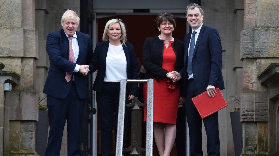 Prime Minister Boris Johnson (L) and Secretary of State for Northern Ireland Julian Smith (R) are greeted by First Minister Arlene Foster of the DUP (2nd R) and Deputy First Minister Michelle O'Neill (2nd L) of Sinn Fein at Stormont on 13 January 2020 in Belfast, Northern Ireland.