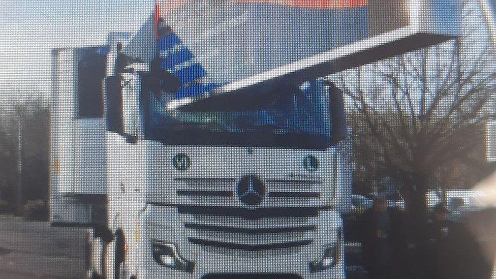 Road sign embedded in lorry window