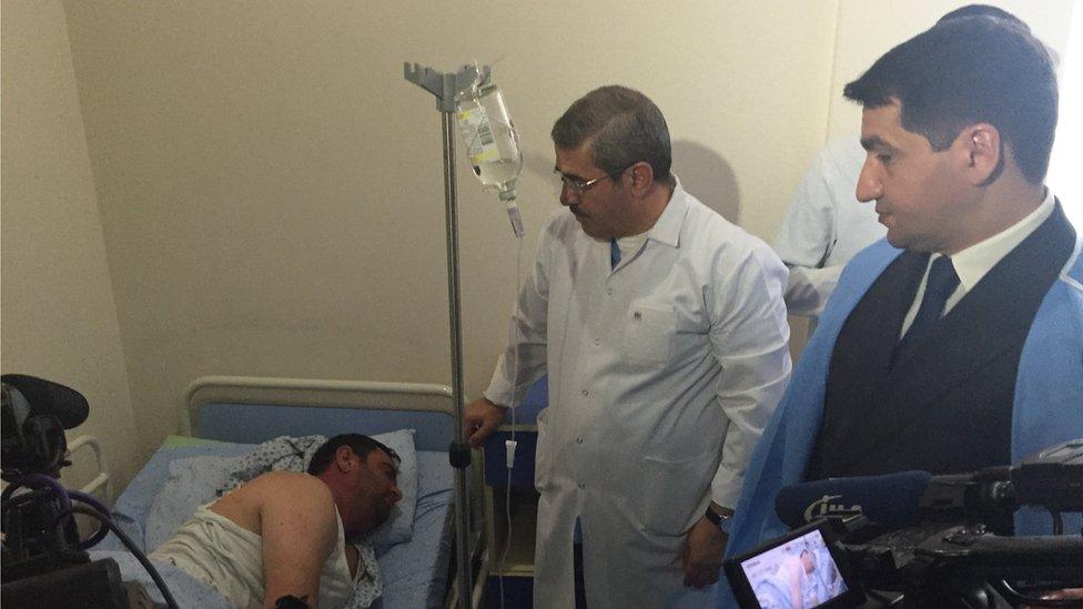 Hikmet Hijaev (right) accompanied journalists to meet people wounded by shelling