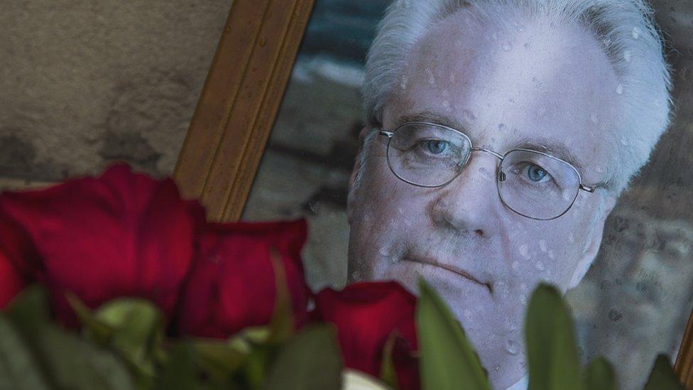 Flowers are placed by a portrait of the late Russian Ambassador to the United Nations Vitaly Churkin, outside the Foreign Ministry headquarters in Moscow, Russia, 21 February 2017