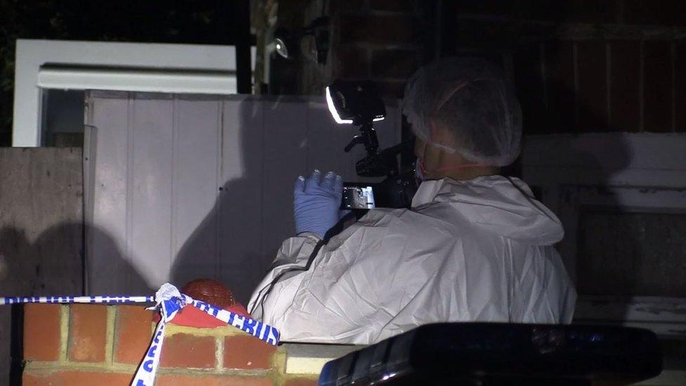 Forensic officer photographing evidence