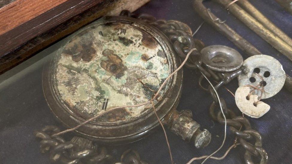 A pocket watch and buttons which were found with the body of L/Sgt Charles Stevens