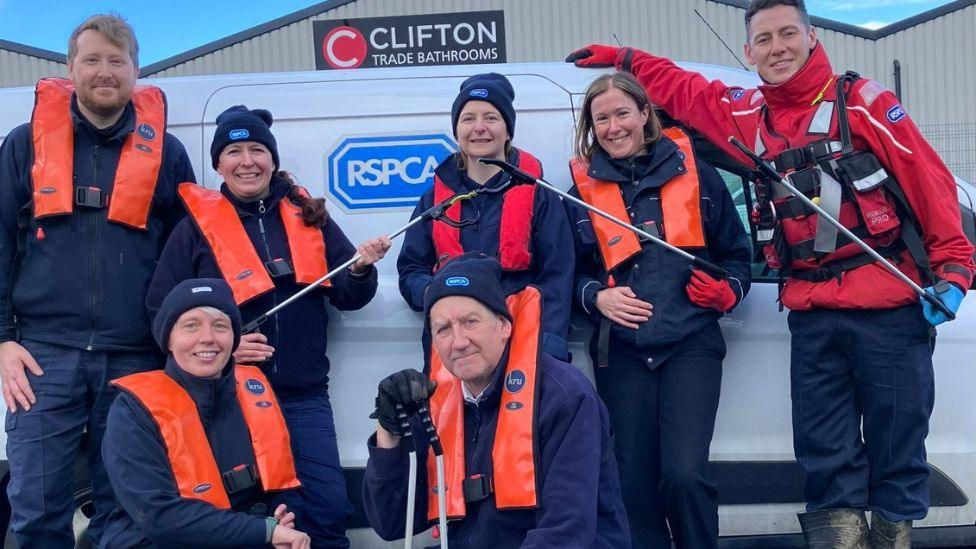 Volunteer litter pickers posing in a group