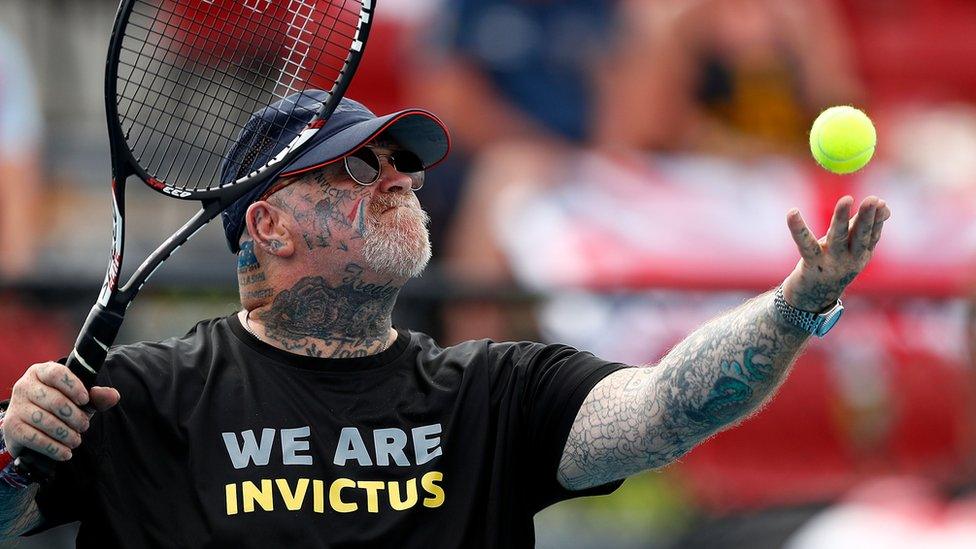 Paul Guest serving in a wheelchair tennis match at the Invictus Games