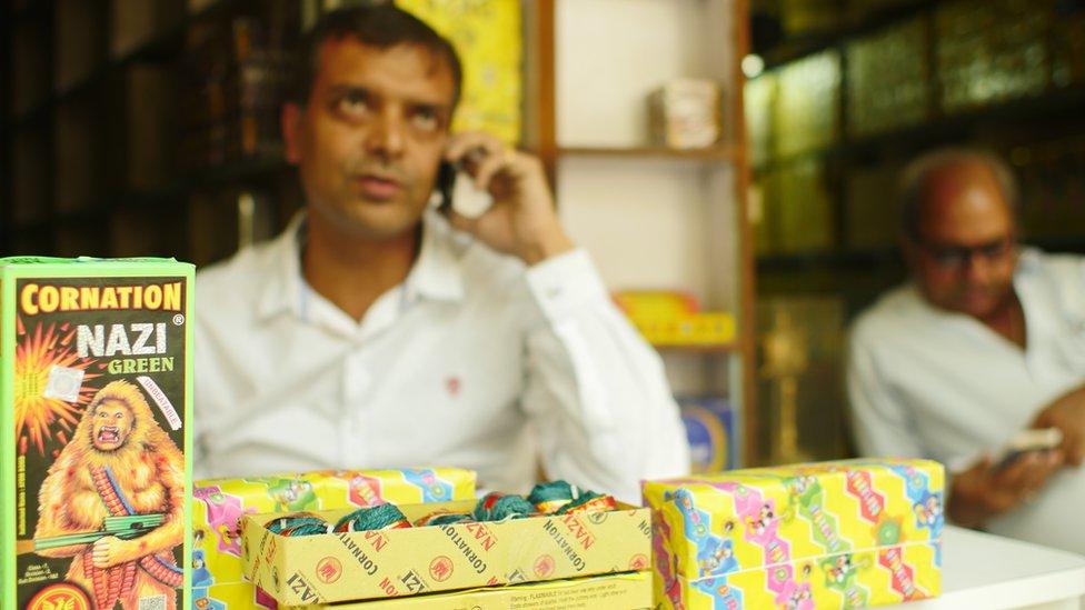 Seller sits near Coronation Nazi Green fireworks for sale