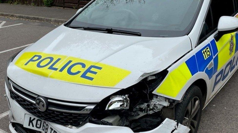 Police car with a damaged bonnet