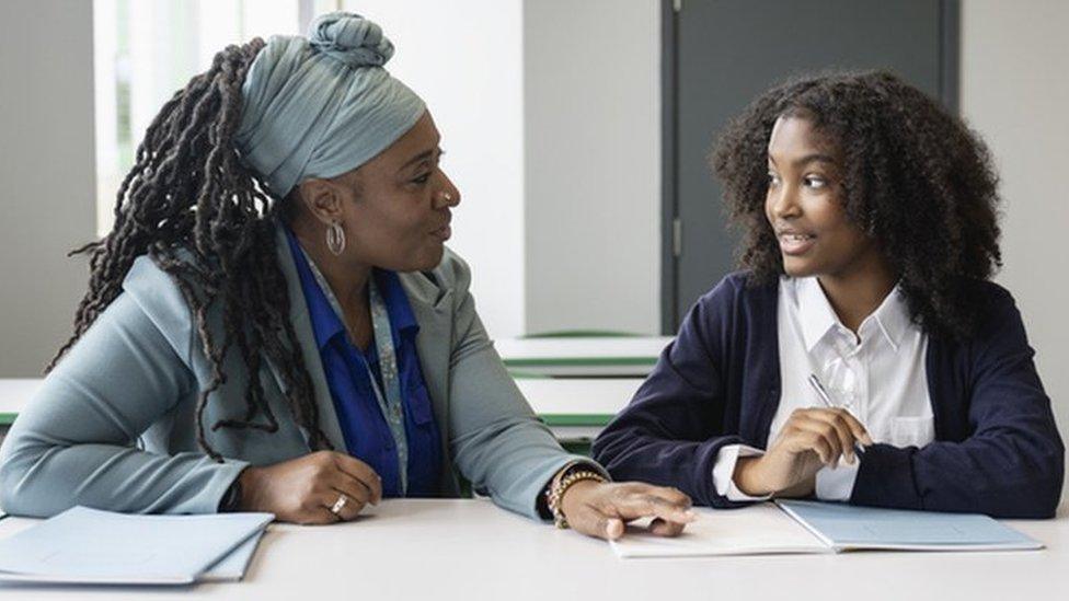 Stock image of teacher and pupil