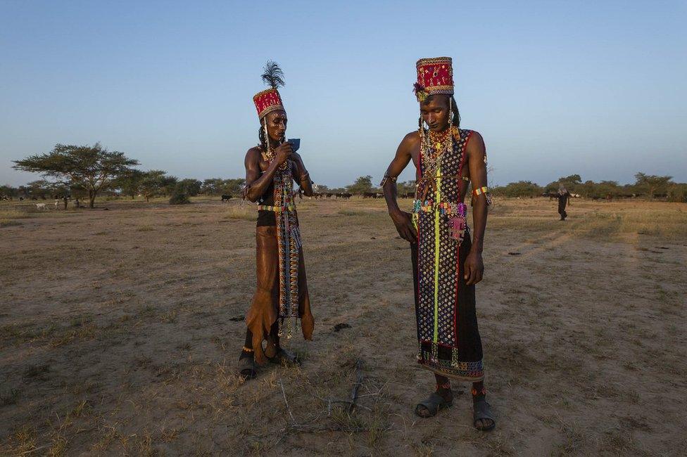 Men take a break from the dancing