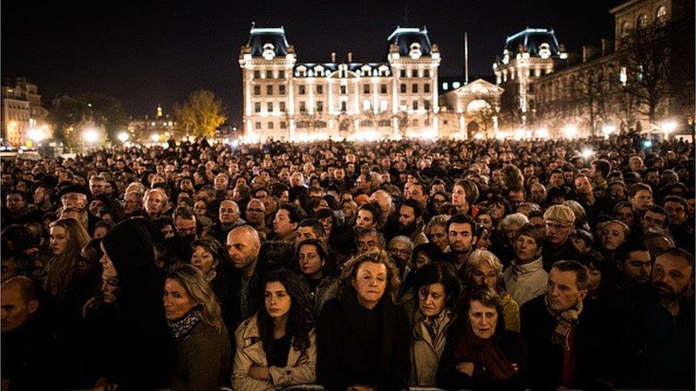 People gather outside of Notre Dame Cathedral ahead of a ceremony to the victims of the Friday's terrorist attacks on November 15, 2015 in Paris, France.