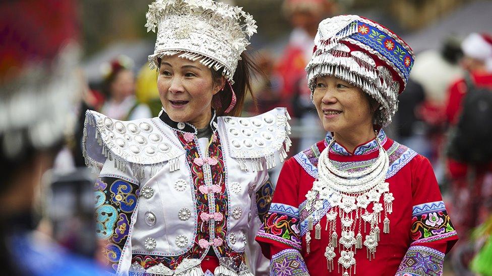 Two women in bright costumes