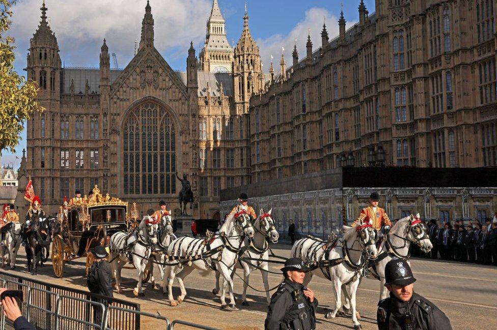 Britain's King Charles III and Britain's Queen Camilla arrive in the Diamond Jubilee State Coach for the State Opening of Parliament in the House of Lords on November 7, 2023 in London, England.