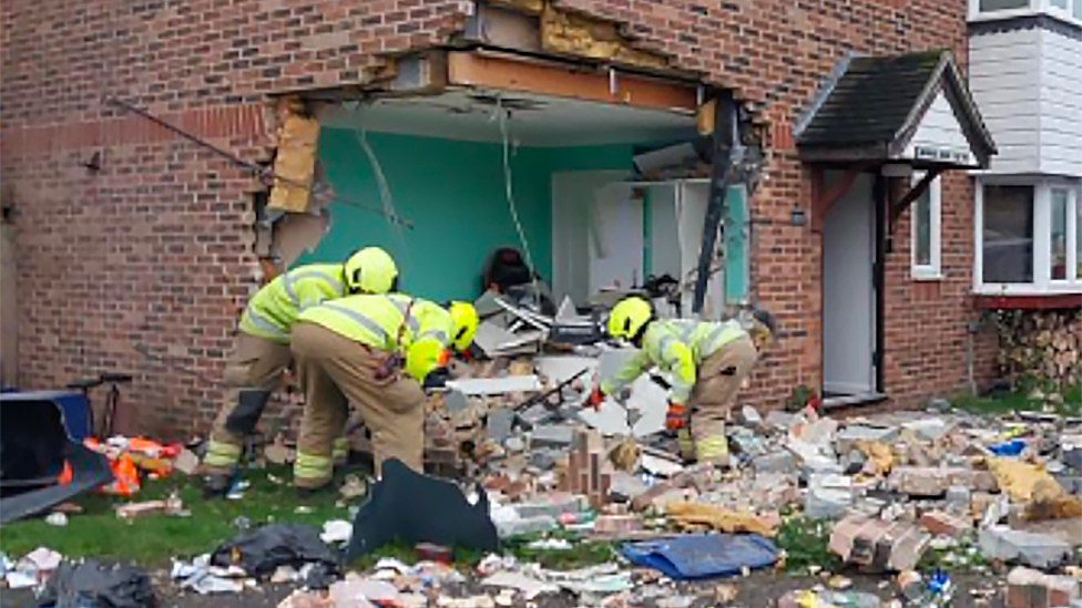 Crews at the scene after a car crashed into a house in Grays