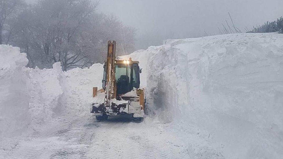 Digger clearing a huge snow drift