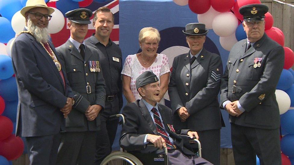 Clifford Storr listens to band on 100th birthday celebration