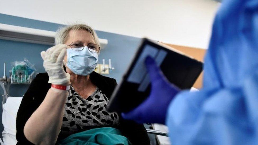 A coronavirus patient in Milan speaking to a relative on a tablet