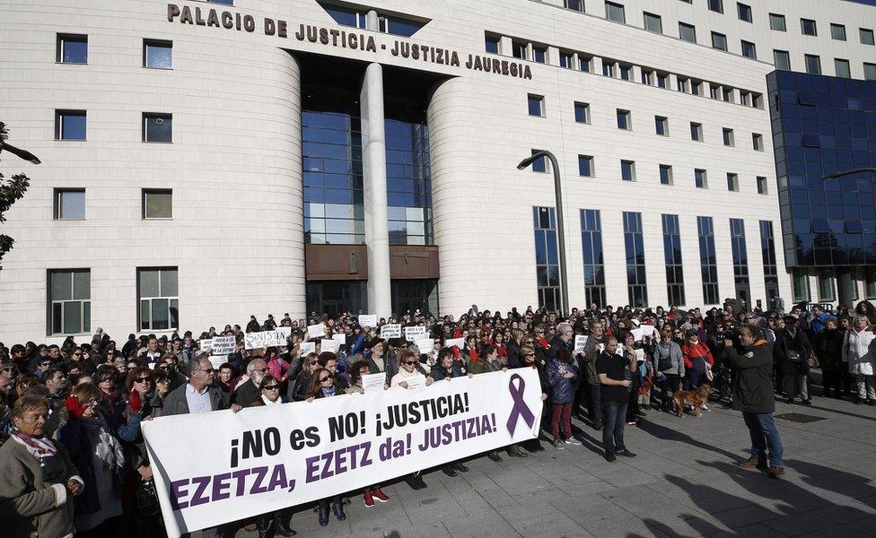 Protesters show a banner that reads "No is no. Justice!" during a protest held at the Superior Court of Navarra