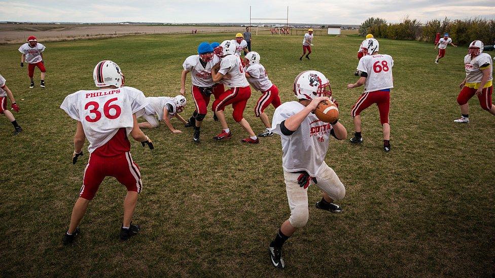 students playing football