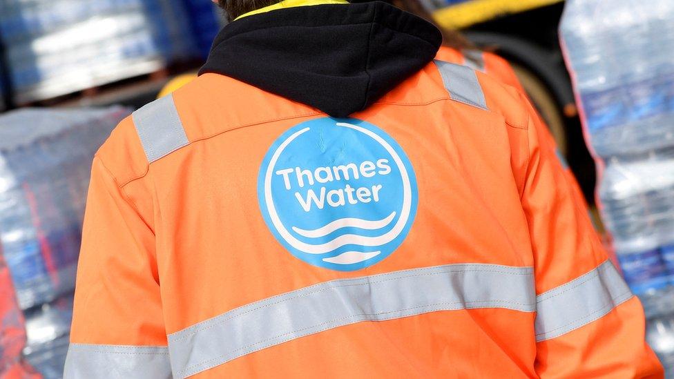 Thames Water worker looking at pallets of bottled water