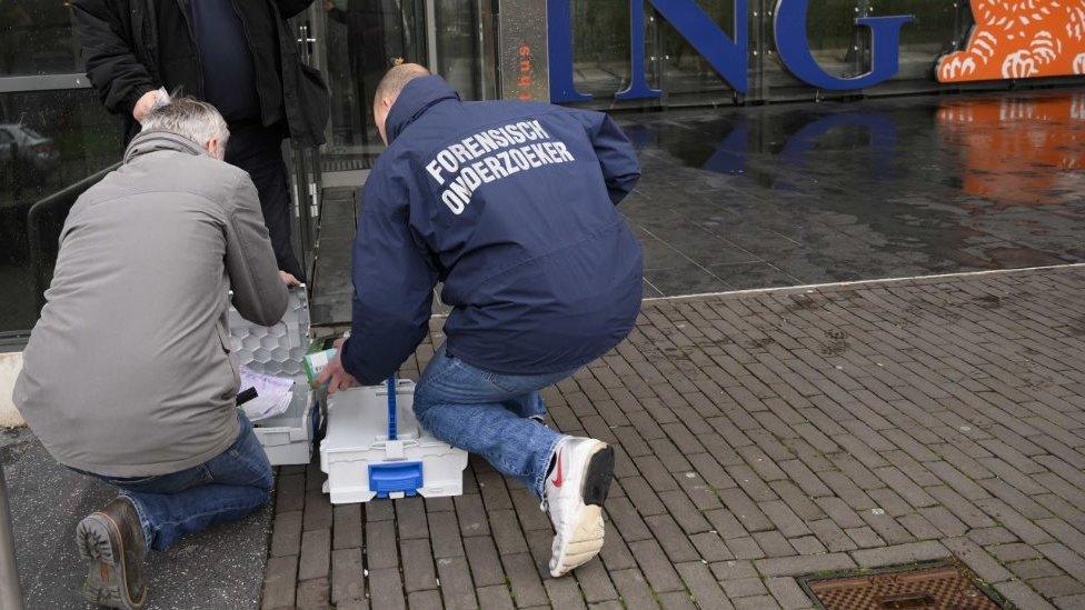 Forensic scientists at the scene of the ING attack on 13 February