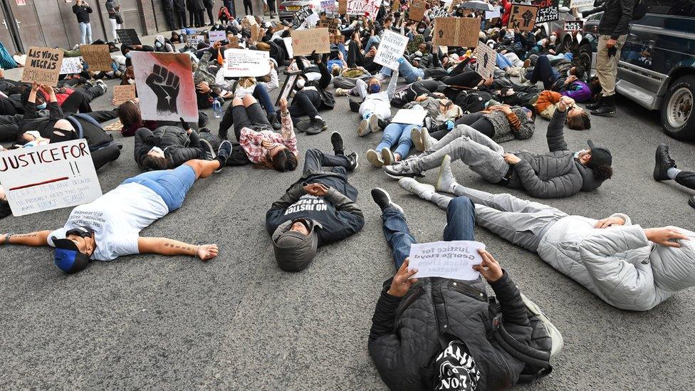 People take part in a Black Lives Matter protest rally at the US Embassy, London