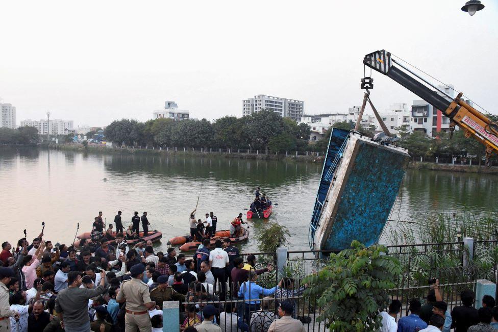 A crane pulls out the boat which capsized in Harni Lake carrying children and teachers who were on a picnic, in Vadodara, India, January 18, 2024.