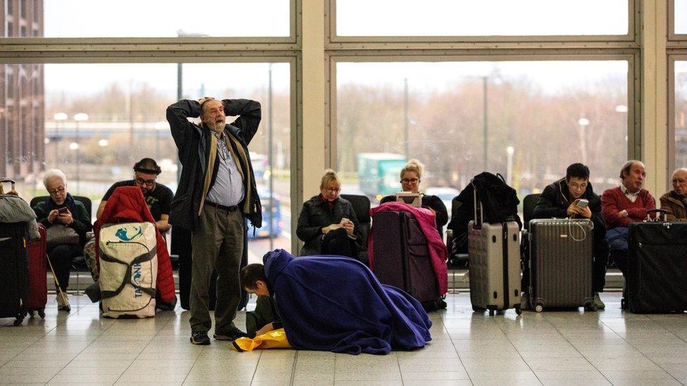 Passengers wait in the South Terminal building at London Gatwick Airport after flights resumed earlier