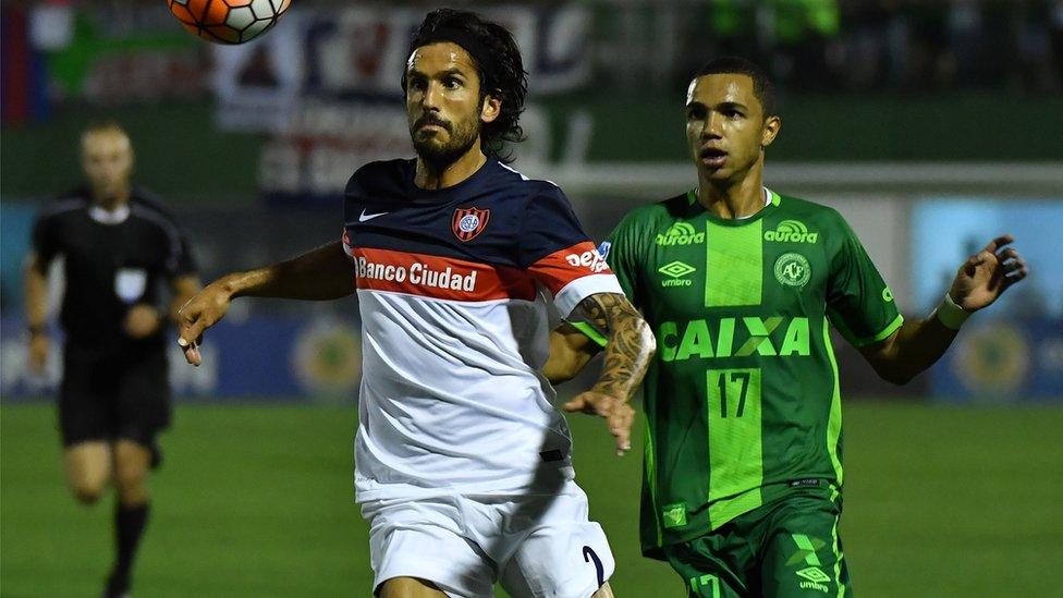 Marcos Angeleri of Brazil's Chapecoense, vies for the ball with Tiaguinho of Argentina's San Lorenzo, during their 2016 Copa Sudamericana semifinal second leg football match on 23 November