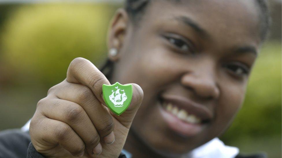 A boy with a Blue Peter badge