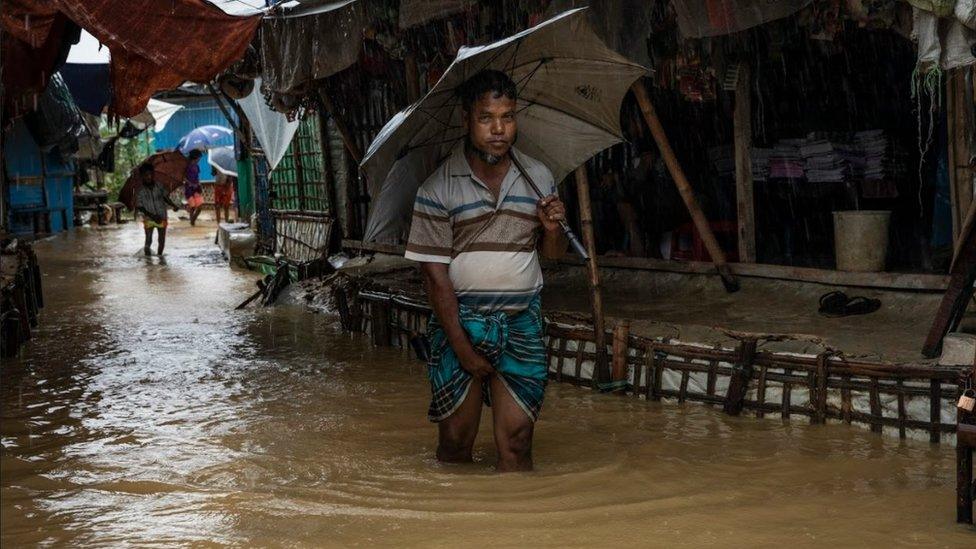 Men wading through flooded street