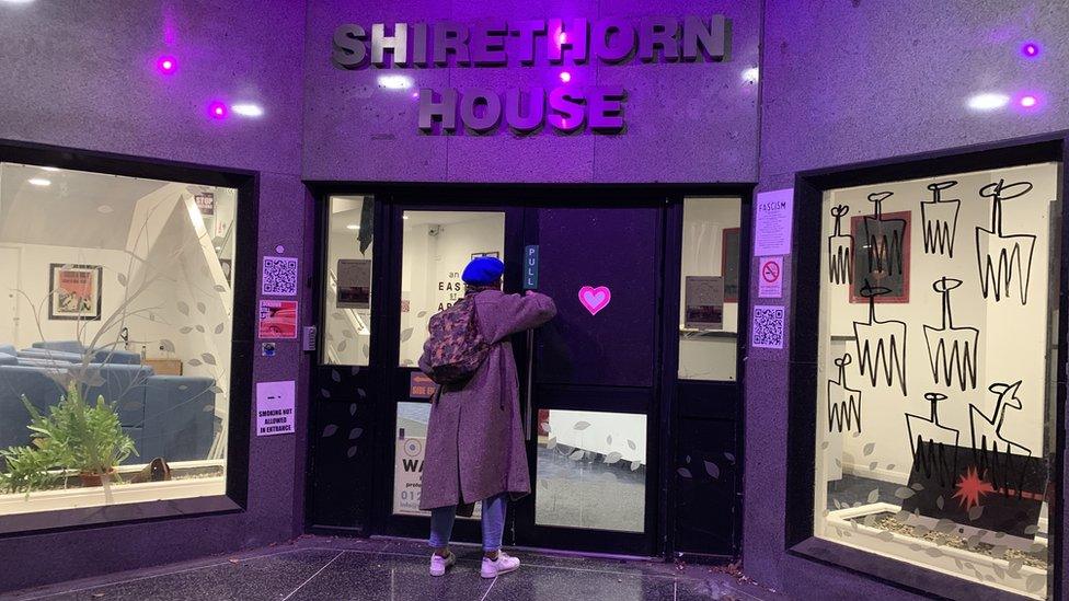 Artist closing the door of Shirethorn House