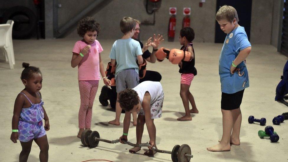 Children entertain themselves in a temporary cyclone shelter in the town of Ayr in far north Queensland as Cyclone Debbie approaches on 28 March 2017.