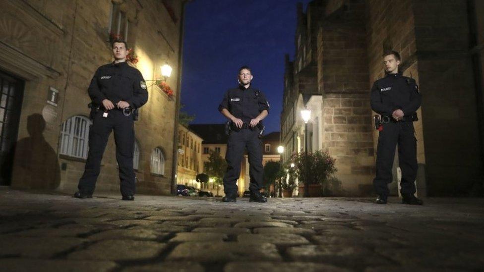 Police officers secure the area after a bomb attack in Ansbach, Germany