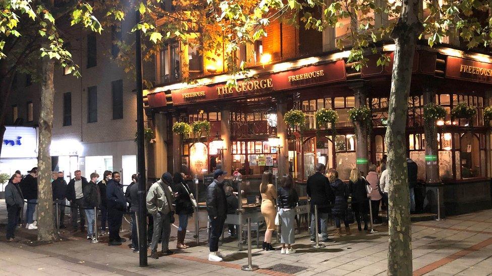 Drinkers queue to get into pub