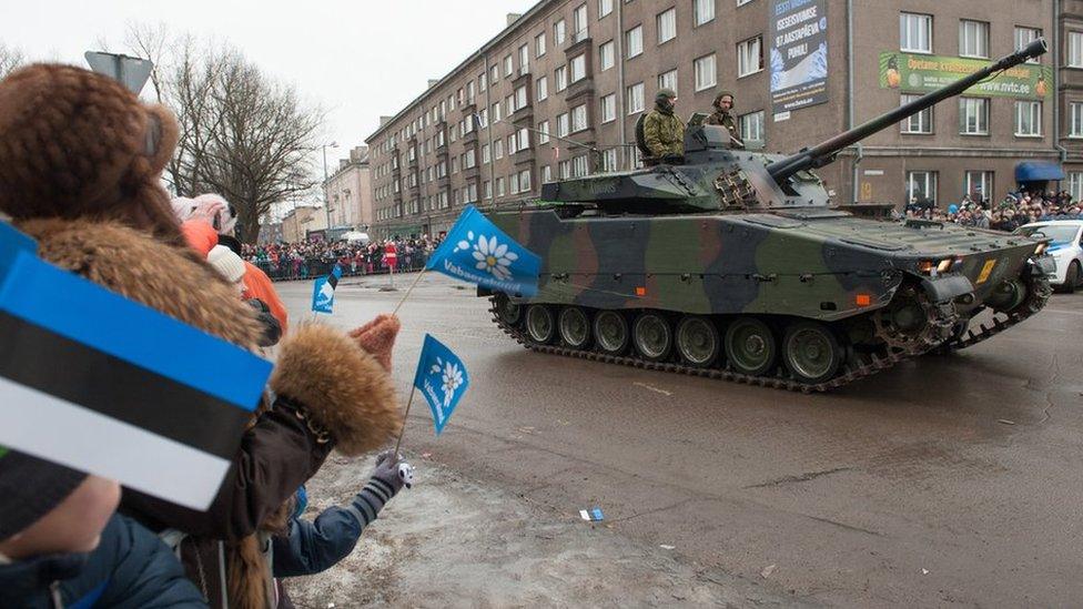 Spectators watch a tank during a parade as part of an event to celebrate 97 years since first achieving independence in 1918 in February 2015 in Narva, Estonia.