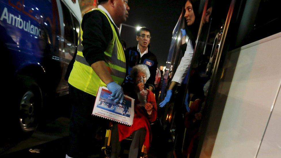 Medics evacuate a wounded woman outside the Address Downtown Dubai hotel and residential block after a fire engulfed the skyscraper in downtown Dubai in the United Arab Emirates December 31, 2015