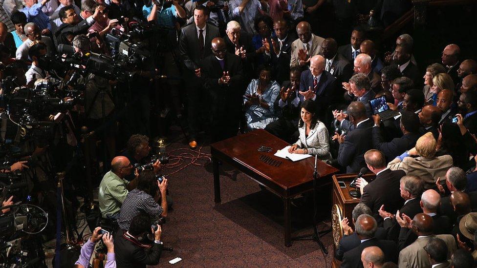 Mrs Haley signs an order to remove the Confederate flag from the South Carolina statehouse