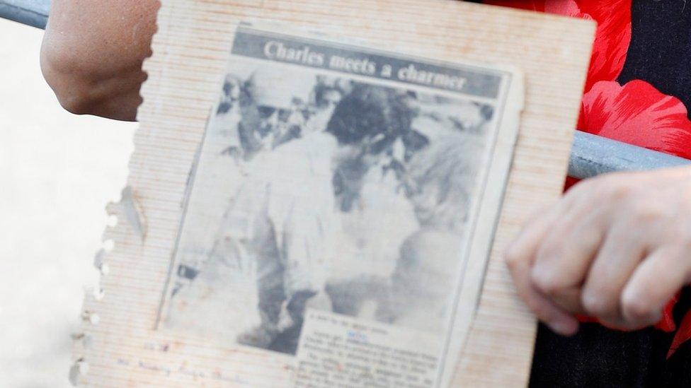 Leila carrying a picture of the kiss