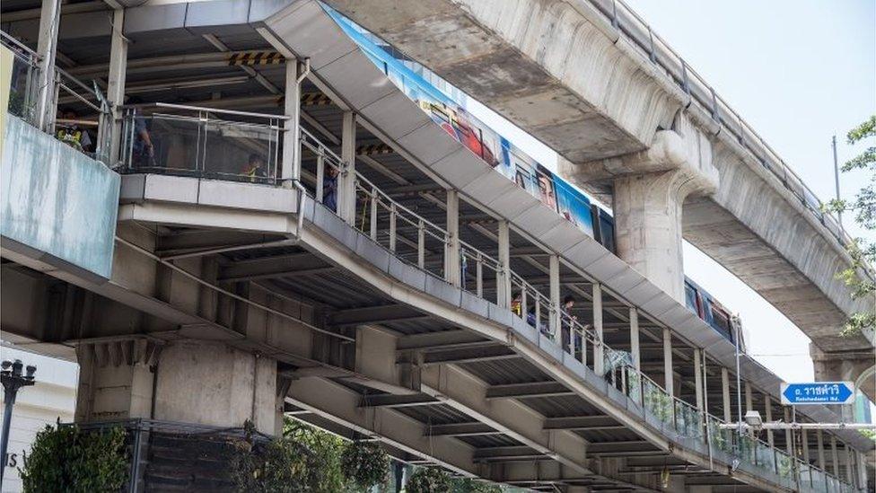 Workers clean up debris from the site of the explosion on August 18, 2015 in Bangkok, Thailand.