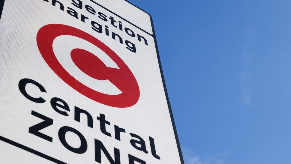 A picture of congestion charge sign close up, with a clear sky in the background.