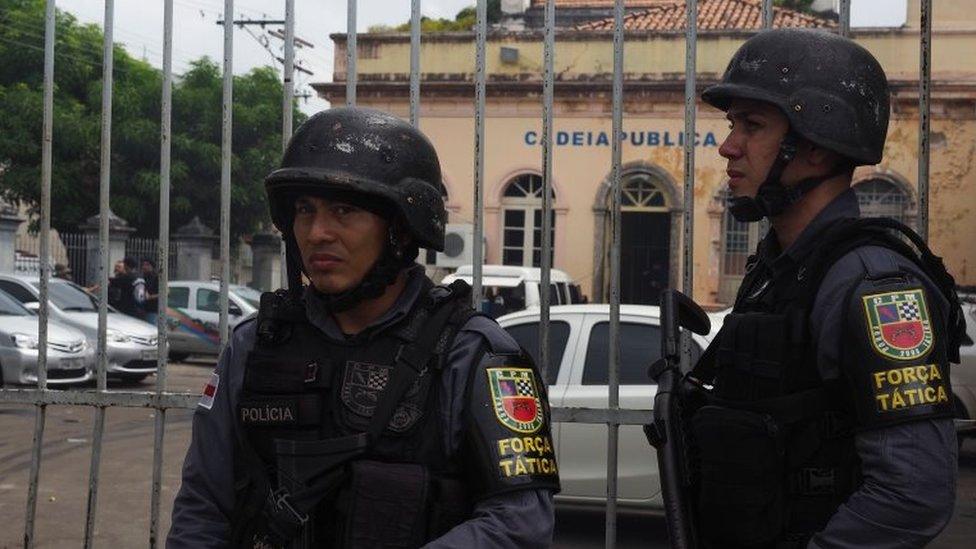 Police officers stand guard at the entrance of the Desembargador Raimundo Vidal Pessoa public jail in Manaus, Amazonas State, Brazil, on January 8, 2017