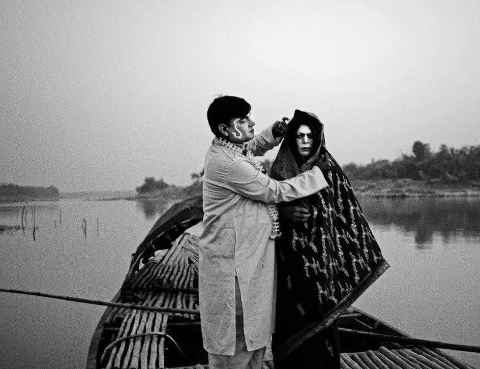 Rabin Kumar Majhi(51yrs) and Anukul Ghosh(63 yrs) posing for a portrait as a newly married couple. Anukul Ghosh used to play female characters in Jatra during 1970-80. Pathra, India.