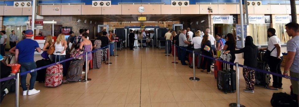 Travellers queue for flights at the airport in Egypt's Red Sea resort of Sharm El-Sheikh on 9 November 2015