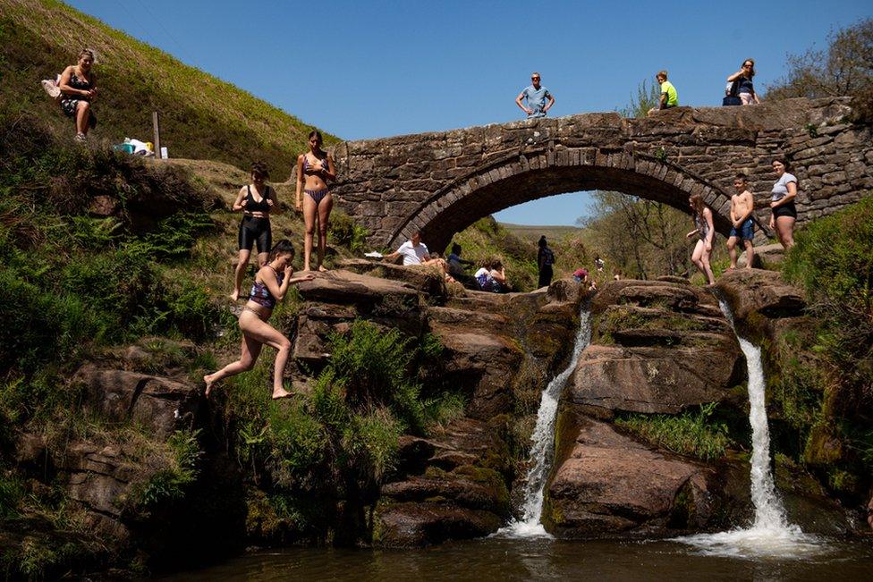 People enjoying the good weather by Three Shires Head on the River Dane, where Cheshire, Derbyshire and Staffordshire meet. 31 March 2020