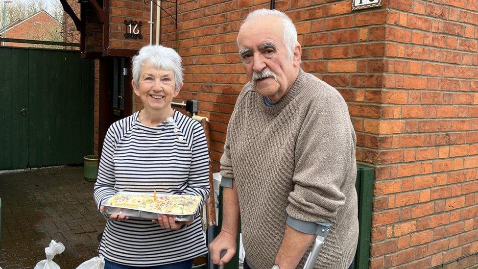 Tewkesbury residents Carol and Keith lived here for 50 years - thought neighbours were dropping around more sandbags but they surprised her with a birthday cake - 74 !