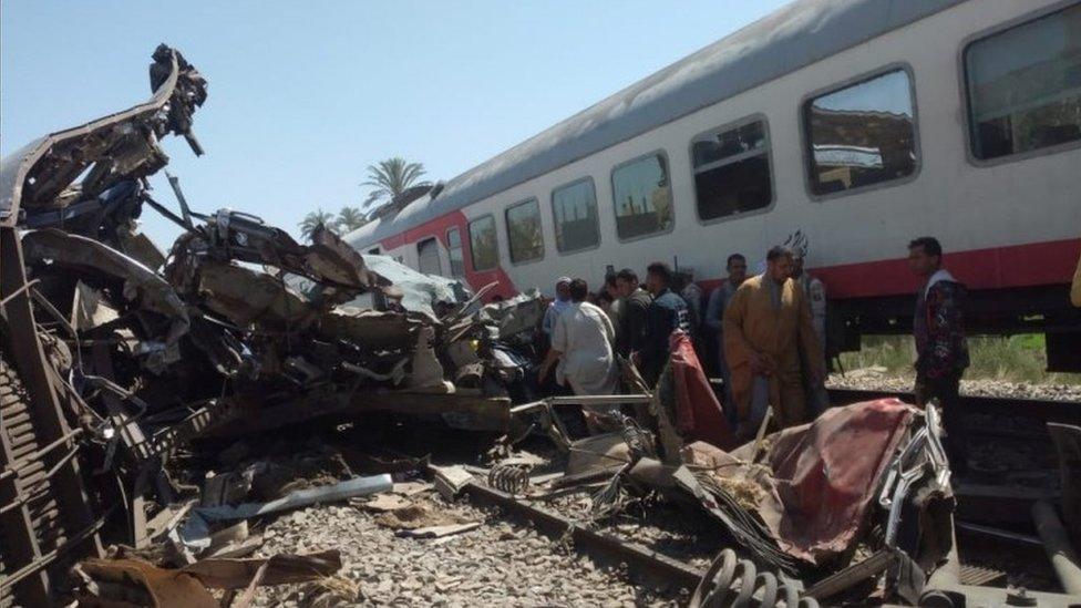 People inspect the train crash scene in Sohag province, Egypt. Photo: 26 March 2021