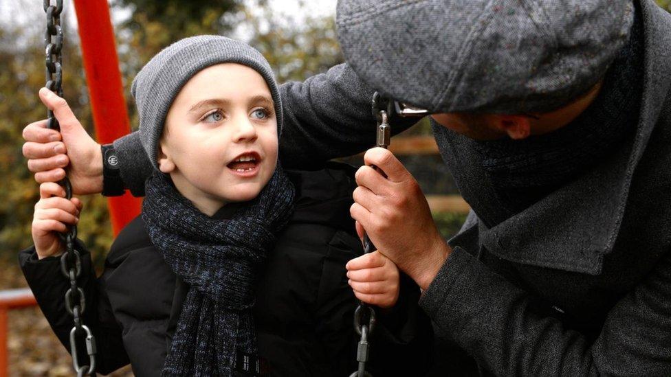 Young actor on swing in park