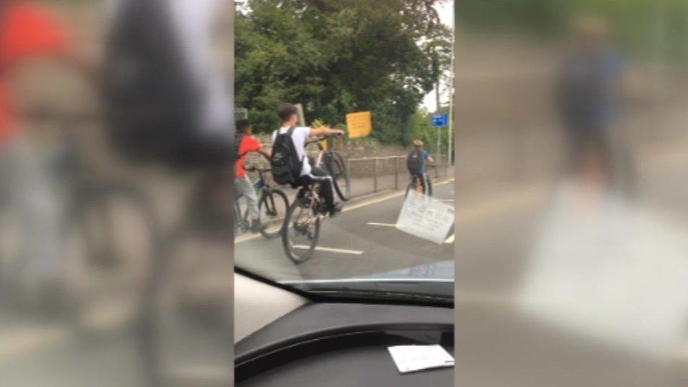 Cyclists doing wheelies on North Road, Cardiff