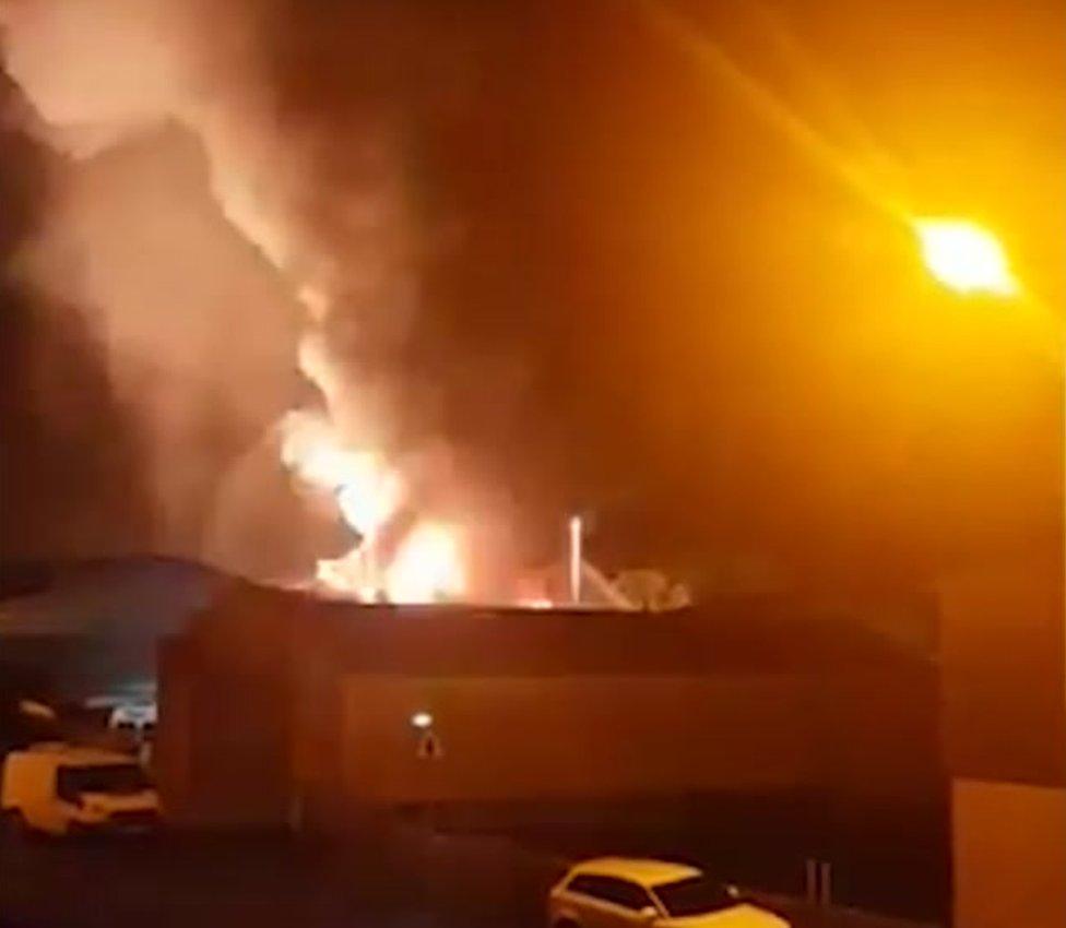 Fire and smoke erupting from an industrial building