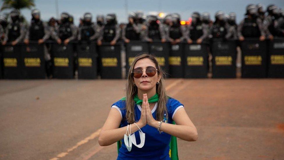 A supporter of Brazil's former President Jair Bolsonaro prays during a demonstration against President Luiz Inacio Lula da Silva, in Brasilia, Brazil, January 8, 2023.